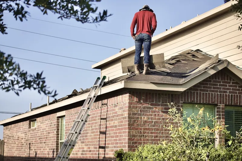 Professional roofer working on a residential roof in Laurel Bay
